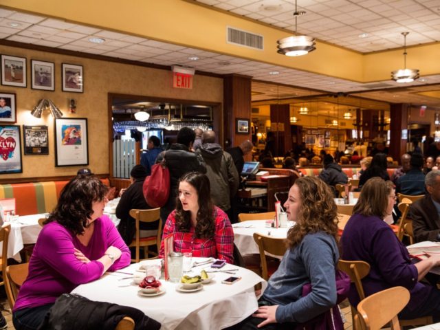 NEW YORK, NY - FEBRUARY 21: Women wait for their food at Junior's restaurant, a staple of