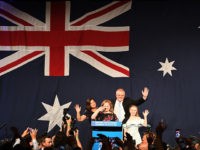 Australia's Prime Minister Scott Morrison (C on the stage) waves to his supporters following a victory speech with his family after winning the Australia's general election in Sydney on May 18, 2019. - Australia's ruling conservative coalition appeared to secure a shock election win on May 18, with the party …