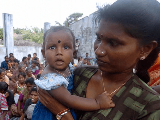 A Sri Lankan mother holds her child in a village Jaffna peninsula.