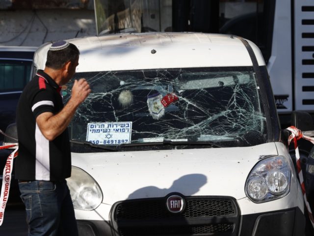 A man walks past a car that was damaged during a rocket strike on the southern Israeli city of Ashkelon near the Gaza border, on May 5, 2019. - Gaza militants fired fresh rocket barrages at Israel early today in a deadly escalation that has seen Israel respond with waves …