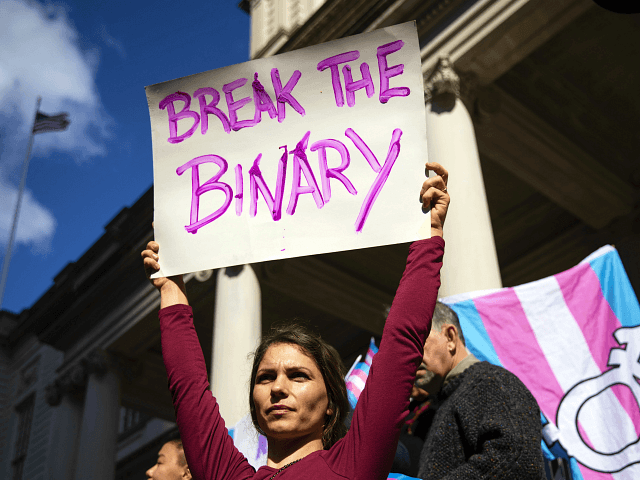 L.G.B.T. activists and their supporters rally in support of transgender people on the step