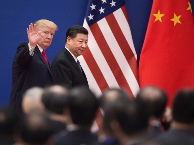 TOPSHOT - US President Donald Trump (L) and China's President Xi Jinping leave a business