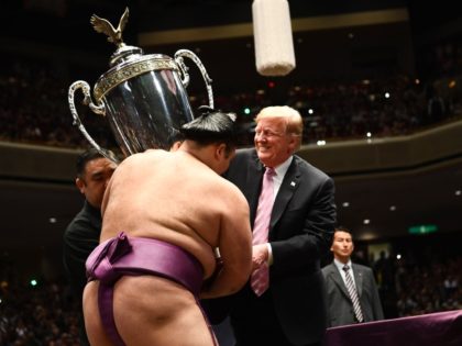 US President Donald Trump presents the President's Cup to sumo wrestler Asanoyama during the Summer Grand Sumo Tournament at Ryogoku Kokugikan Stadium in Tokyo on May 26, 2019. (Photo by Brendan SMIALOWSKI / AFP) (Photo credit should read BRENDAN SMIALOWSKI/AFP/Getty Images)