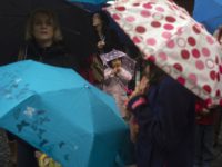 Tourists shelter from the rain under umbrellas as they wait for the moving moment of the astronomical clock at the Old Town Square on May 30, 2013 during heavy rain in Prague. AFP PHOTO / MICHAL CIZEK (Photo credit should read MICHAL CIZEK/AFP/Getty Images)