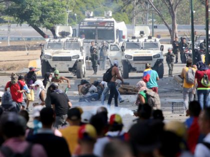 CARACAS, VENEZUELA - MAY 01: Venezuelan National Guard throw tear gas to Pro-Juan Guaidó