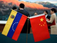 The Chinese and Venezuelan flag are polaced on the table where a ceremony to sign agreements between the two nations took place at the Great Hall of the People in Beijing Wednesday, Sept. 24, 2008. Chavez said his country's oil exports to China could soar to 1 million barrels a …