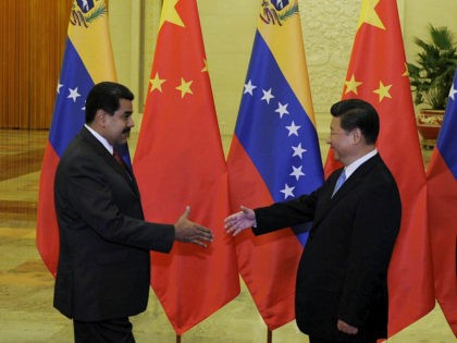 BEIJING, CHINA - SEPTEMBER 1: Chinese President Xi Jinping (R) shakes hands with Venezuela's President Nicolas Maduro before their meeting at the Great Hall of the People September 1, 2015 in Beijing, China. Maduro is visiting China seeking financial assistance as Venezuela has been hit hard by recession. (Photo by …