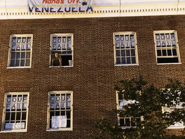 An activist who supports Venezuelan Nicolas Maduro stands by the window of the Venezuelan
