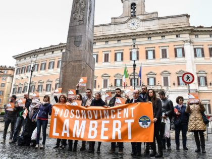 Italian members of the support committee of French quadriplegic Vincent Lambert, hold a banner reading "#I'm Vincent Lambert" as they protest in front of Montecitorio, the Italian Parliament, in central Rome, on May 20, 2019. - Vincent Lambert, a quadriplegic man who has been in a vegetative state for the …