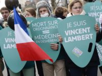 A woman holds a placard reading "I am Vincent Lambert" (a quadriplegic man who is currently on artificial life support in a hospital in France) as she takes part in a walk for life "Marche pour la vie", on January 25, 2015, in Paris. AFP PHOTO / BERTRAND GUAY (Photo …
