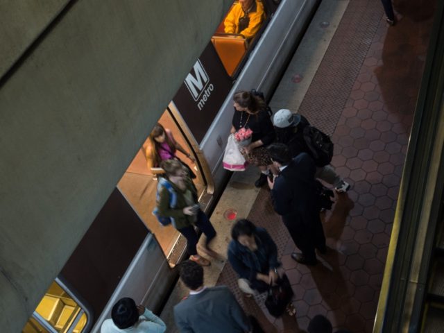 Commuters get off a Metro train as others wait to go aboard at the L'Enfant Plaza station