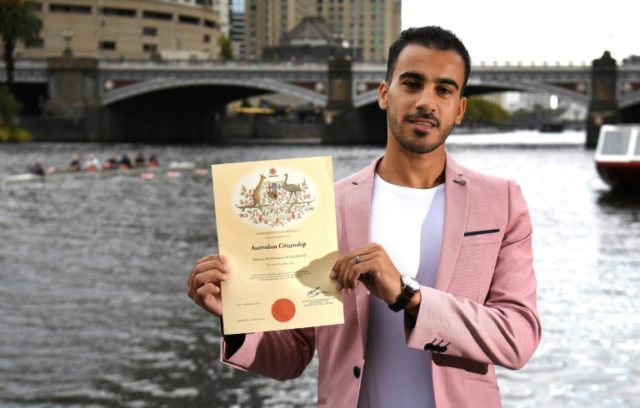 Refugee footballer votes after getting Australian citizenship