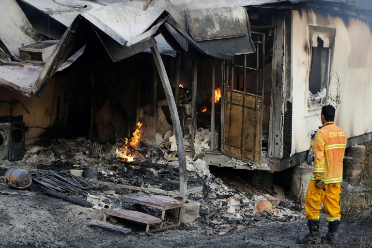 Israel remains on high alert after wildfires destroy 40 homes (AFP).