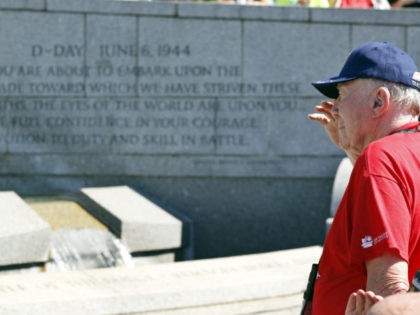 A WWII veteran and member of an honor flight from California salutes as the colors are presented, on the anniversary of D-Day, Monday, June 6, 2016, at the World War II Memorial in Washington. (AP Photo/Alex Brandon)