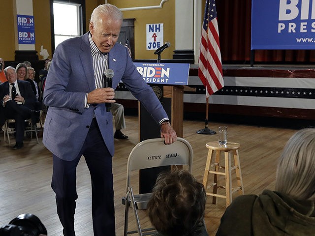 Former vice president and Democratic presidential candidate Joe Biden brings a chair over for a woman in the audience during a campaign event, Tuesday, June 4, 2019, in Berlin, N.H. (AP Photo/Elise Amendola)