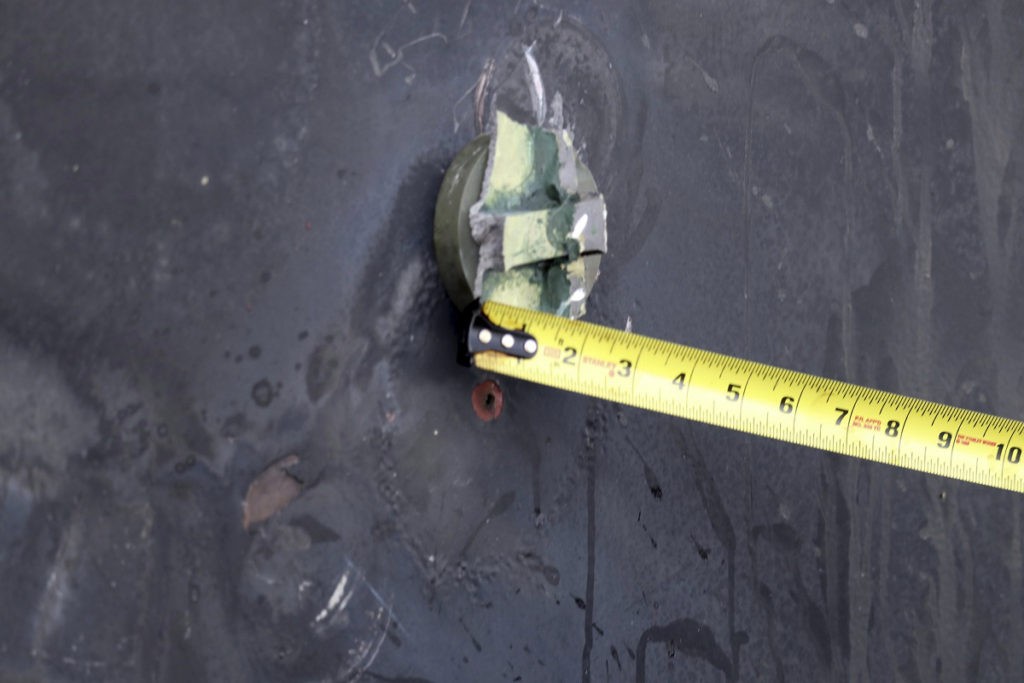 This image released by the U.S. Department of Defense on Monday, June 17, 2019, according to the Navy, shows the aluminum and green composite material left behind following removal of an unexploded limpet mine used in an attack on the starboard side of motor vessel M/T Kokuka Courageous, while operating in the Gulf of Oman. (U.S. Department of Defense via AP)