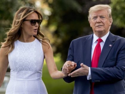 President Donald Trump and first lady Melania Trump walk towards members of the media befo
