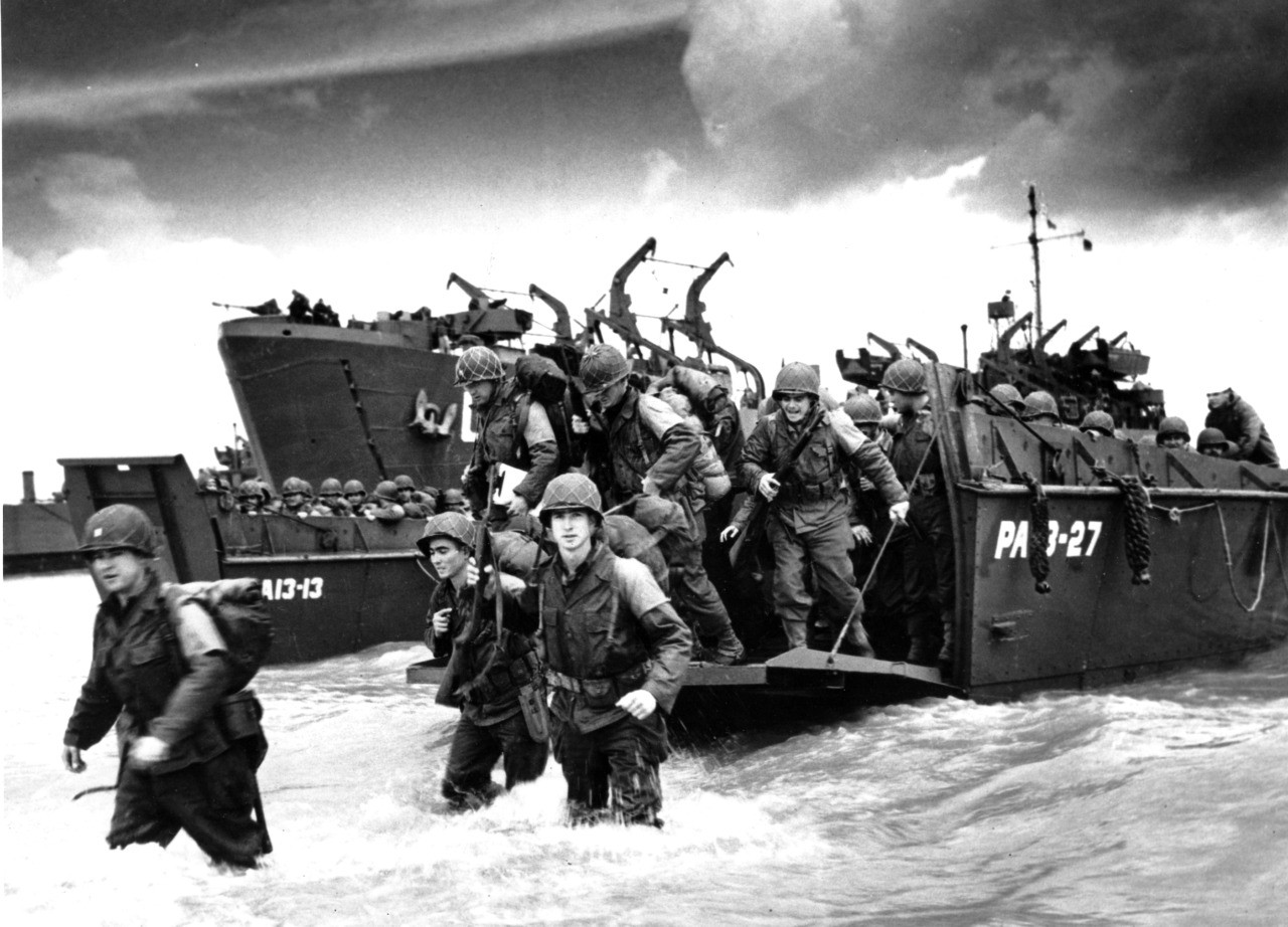 American reinforcements, arrive on the beaches of Normandy from a Coast Guard landing barge into the surf on the French coast on June 23, 1944 during World War II. They will reinforce fighting units that secured the Norman beachhead and spread north toward Cherbourg. (AP Photo/U.S. COAST GUARD)
