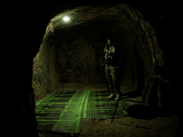 A soldier with the Afghan National Army (ANA) stands inside a room which was previously pa