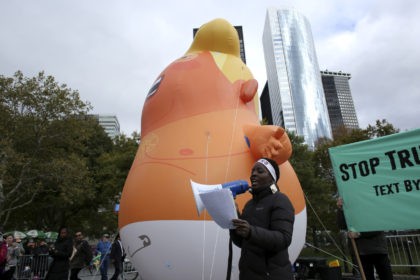 NEW YORK, NY - OCTOBER 28: An activist speaks on the mic as The Baby Trump Balloon rises a