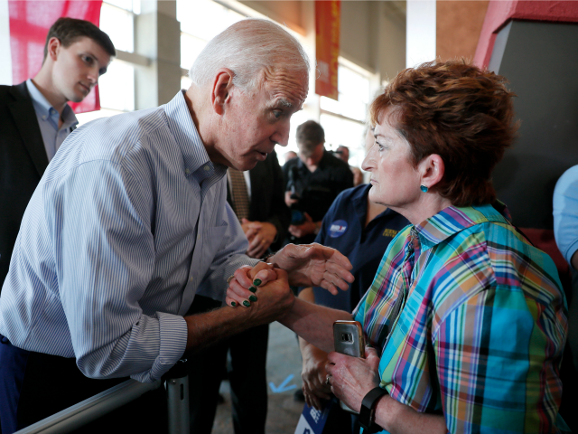 Democratic presidential candidate former Vice President Joe Biden, left, takes a moment to