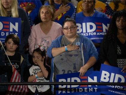 Supporters pledge allegiance to the flag before listening to Former U.S. Vice President Jo