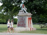 People walk past a monument to Confederate soldiers in Centennial Park Monday, June 17, 2019, in Nashville, Tenn. Police discovered Monday the monument was vandalized with red paint and the phrase "They were racists" was painted over the names of Civil War soldiers. (AP Photo/Mark Humphrey)