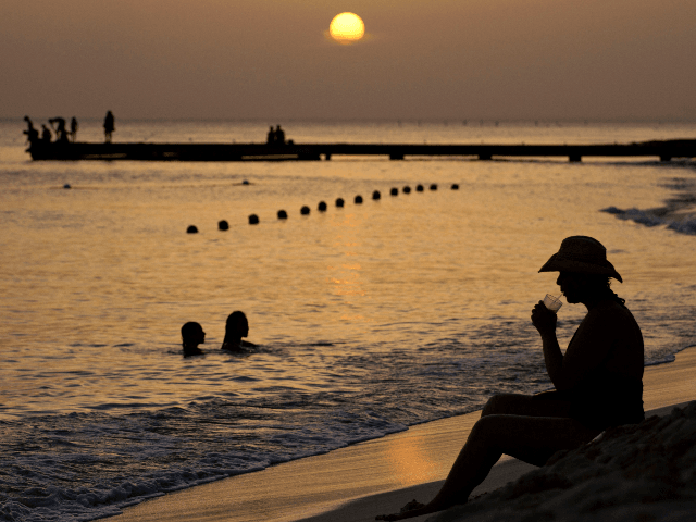 A person has a drink at Dominicus beach in Bayahibe, La Altagracia province, Dominican Rep