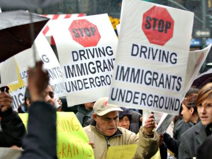 Immigrants and community leaders in New York City protest on April 13, 2004, against a state policy that denies driver's licenses to hundreds of thousands of immigrants. The protest followed a crackdown on individuals without Social Security numbers. (Getty Images/Stephen Chernin)
