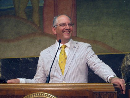 Democratic Gov. John Bel Edwards smiles as he describes the end of a legislative session t