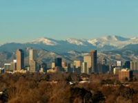 The Rocky Mountains rise beyond Denver skyline Sunday, Jan. 24, 2016. (AP Photo/Charlie Riedel)