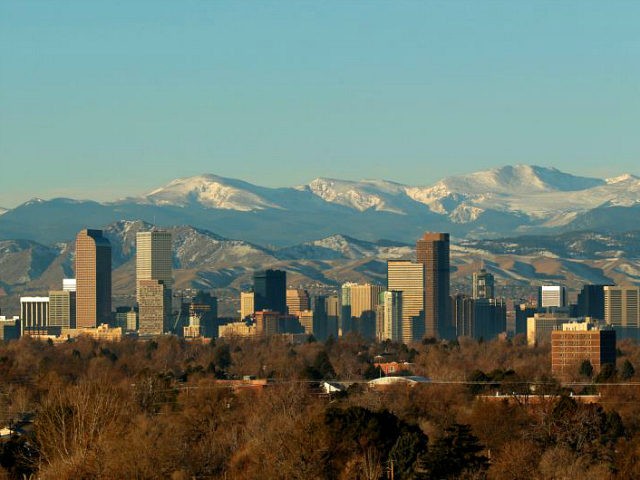 The Rocky Mountains rise beyond Denver skyline Sunday, Jan. 24, 2016. (AP Photo/Charlie Riedel)