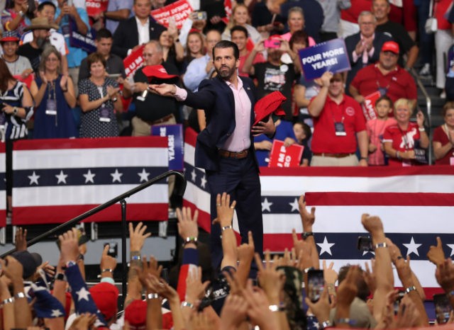 ORLANDO, FLORIDA - JUNE 18: Donald Trump Jr. tosses campaign hats to the crowd before his