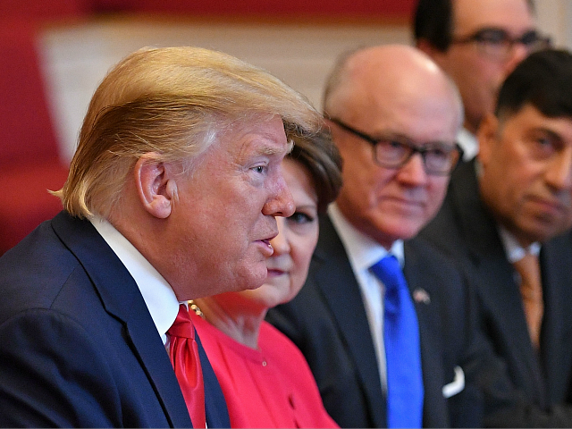 US President Donald Trump (L) speaks at a business roundtable discussion at St. Jamess Palace in London on June 4, 2019, on the second day of the US president and the First Lady's three-day State Visit to the UK. - US President Donald Trump turns from pomp and ceremony to …