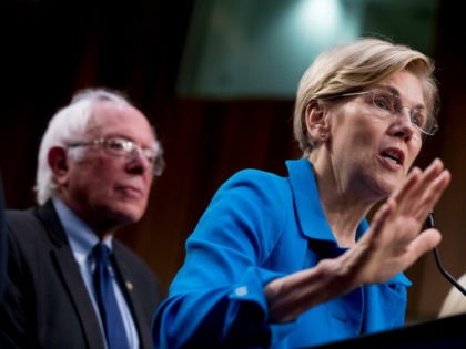 Sen. Elizabeth Warren, D-Mass., right, accompanied by Sen. Bernie Sanders, I-Vt., left, sp