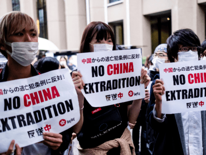 Foreign students In Japan hold up a placard which says No China Extradition at Meiji University on June 12, 2019 in Tokyo, Japan. Students gathered in Meiji University to show their support as Hong Kong braced for another mass rally in a show of strength against the government over a …