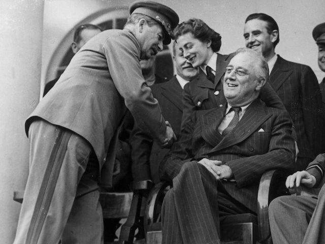 7th December 1943: American statesman Franklin Delano Roosevelt, the 32nd President of the United States of America, British Prime Minister Winston Churchill and Soviet leader Joseph Stalin during a conference at Teheran. Stalin greets Sarah Churchill. (Photo by Evening Standard/Getty Images)