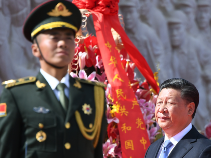 Chinese President Xi Jinping walks past a soldier after laying a wreath at the Monument to the People's Heroes during a ceremony in Beijing's Tiananmen Square, on the eve of National Day on September 30, 2018. - China marks its National Day, the 69th anniversary of the founding of the …