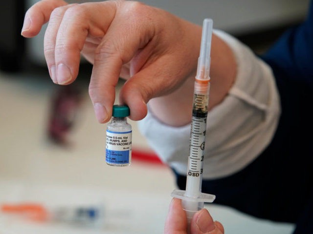 PROVO, UT - APRIL 29: A nurse holds up a one dose bottle and a prepared syringe of measles