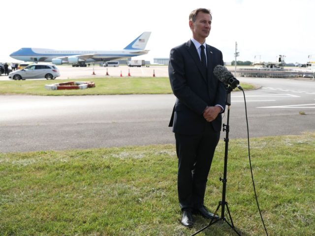 Britain's Foreign Secretary Jeremy Hunt speaks to the media at Stansted Airport, nort