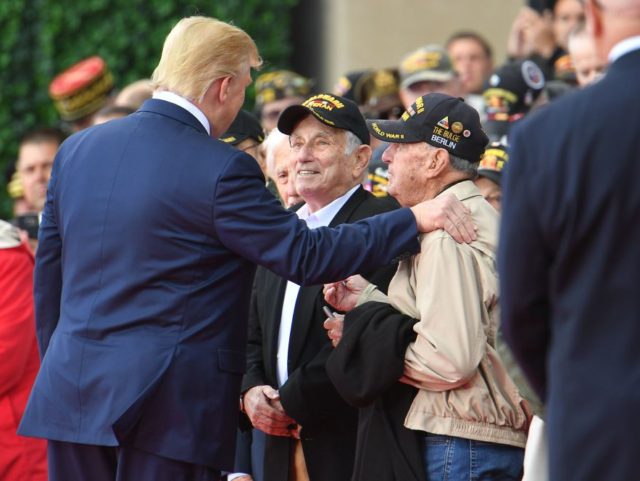 TOPSHOT - US President Donald Trump (L) meets with WWII veterans during a French-US ceremony at the Normandy American Cemetery and Memorial in Colleville-sur-Mer, Normandy, northwestern France, on June 6, 2019, as part of D-Day commemorations marking the 75th anniversary of the World War II Allied landings in Normandy. (Photo …