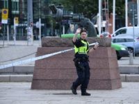 A policewoman stands guard outside the central train station after a man threatened to detonate a bomb in Malmö in southern Sweden on June 10, 2019. - The station building was evacuated due to alarms about a suspected object. The man was wounded by police and his bag destroyed by …