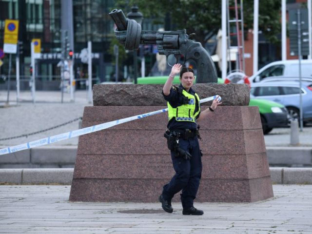 A policewoman stands guard outside the central train station after a man threatened to detonate a bomb in Malmö in southern Sweden on June 10, 2019. - The station building was evacuated due to alarms about a suspected object. The man was wounded by police and his bag destroyed by …