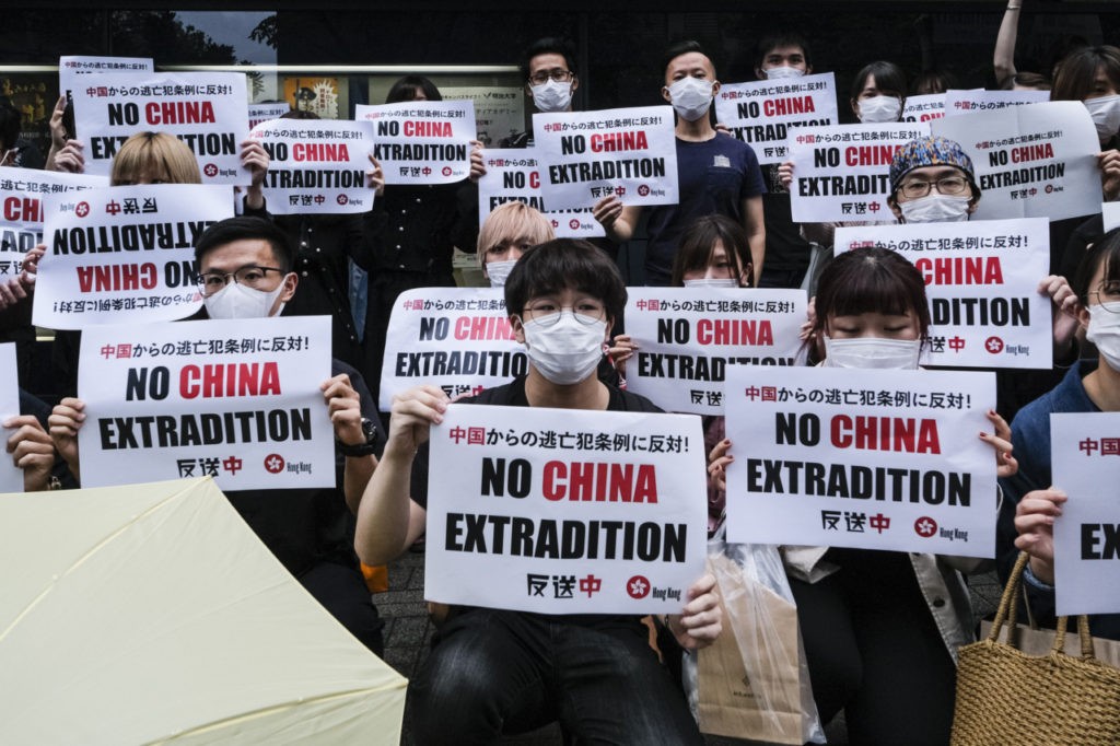 HONG KONG, HONG KONG - JUNE 12: Foreign students In Japan hold up a placard which says 'No China Extradition' at Meiji University on June 12, 2019 in Tokyo, Japan. Students gathered in Meiji University to show their support as Hong Kong braced for another mass rally in a show of strength against the government over a divisive plan to allow extraditions to China. (Photo by Keith Tsuji/Getty Images)