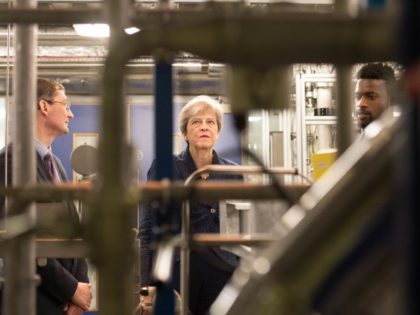 British Prime Minister Theresa May visits Imperial College in London where she was shown machinery which converts carbon dioxide into oxygen after her announcement that the UK is to set a legally binding target to end its contribution to climate change by 2050 on June 12, 2019. (Photo by Stefan …