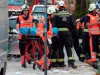 Austrian rescuers and firefighters work at the site of an explosion in which an apartment building collapsed in the city center of Vienna, Austria on June 26, 2019. - At least two people were seriously injured, ten lightly, and searches continue for possible missing people, following what medias report to …