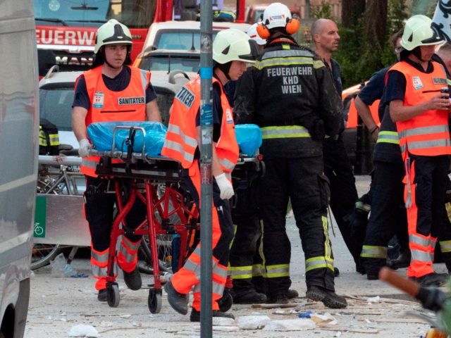 Austrian rescuers and firefighters work at the site of an explosion in which an apartment