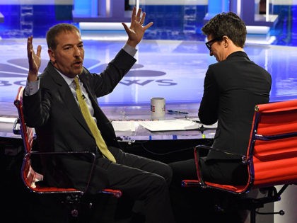 Moderators Chuck Todd (L) speaks to audience during a technical problem alongside Rachel Maddow as they host the first night of the Democratic presidential primary debate hosted by NBC News at the Adrienne Arsht Center for the Performing Arts in Miami, Florida, on June 26, 2019. (Photo by JIM WATSON …