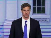 MIAMI, FLORIDA - JUNE 26: Sen. Cory Booker (D-NJ) and Sen. Elizabeth Warren (D-MA) talk as former Texas congressman Beto O'Rourke looks on during the first night of the Democratic presidential debate on June 26, 2019 in Miami, Florida. A field of 20 Democratic presidential candidates was split into two …