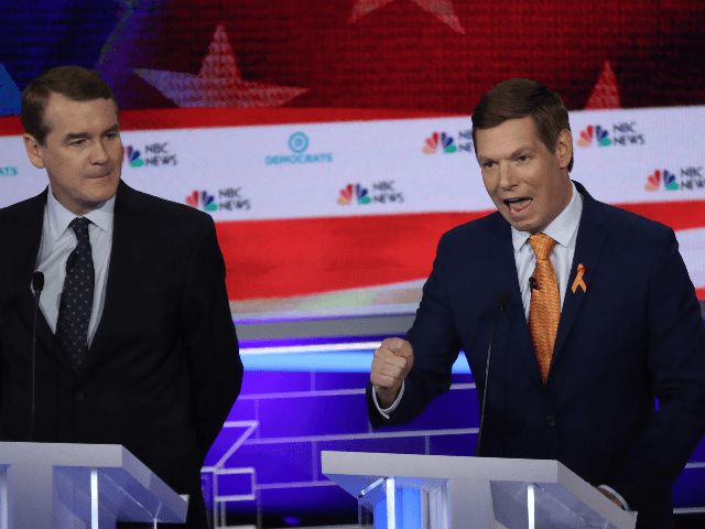 Rep. Eric Swalwell (D-CA) speaks as Sen. Michael Bennet (D-CO) looks on during the second